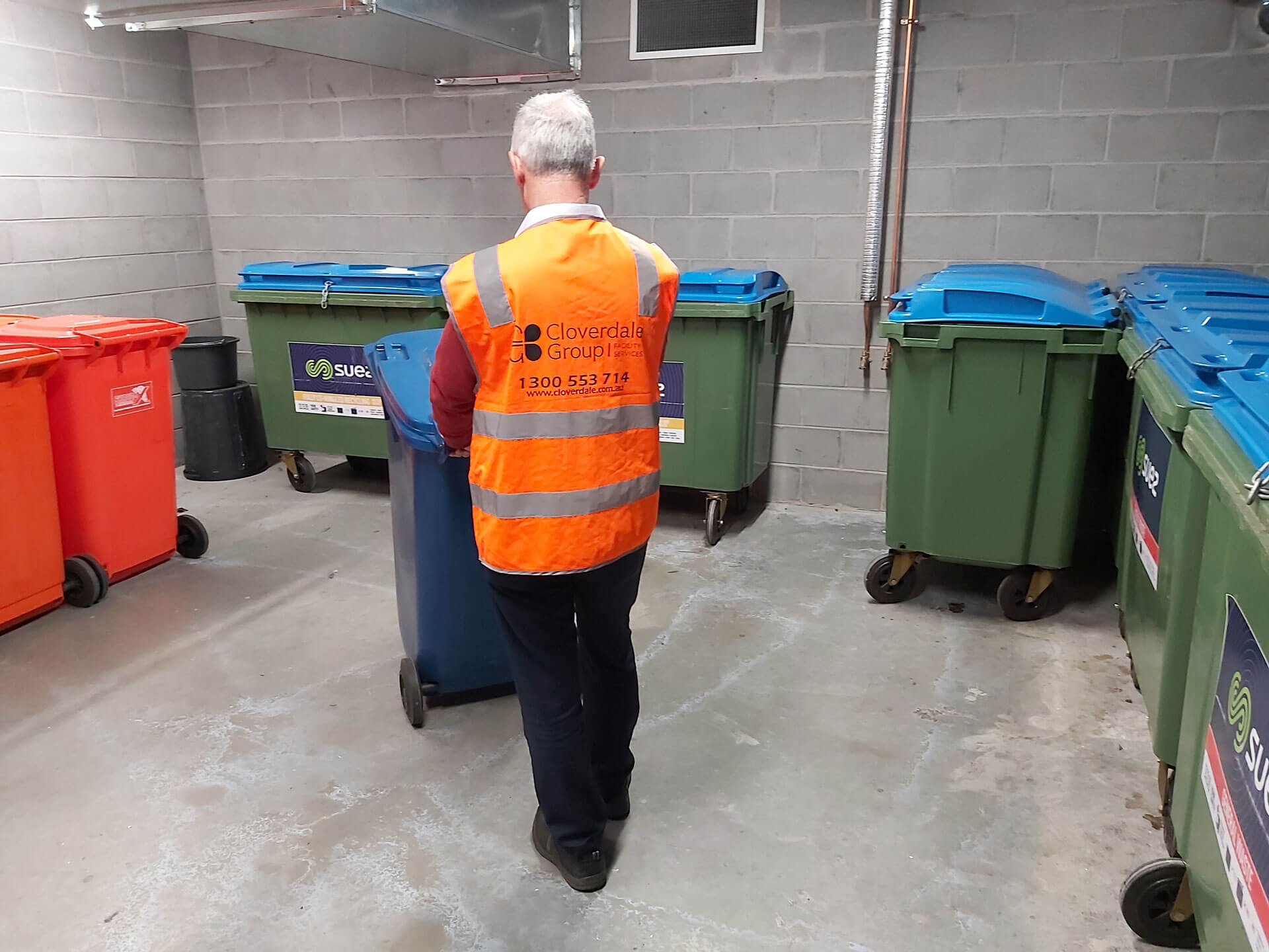 Caretaker pushing bins external